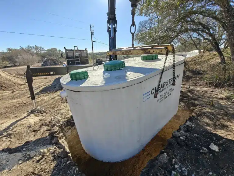 FJR septic installers setting a clearstream aerobic tank for a new septic system