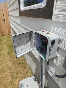 FJR Septic Installers doing maintenance on a control panel in Bexar county